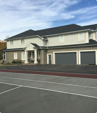 Modern two-story suburban house with gray roof and three-car garage