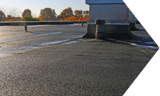 Commercial flat roof with HVAC units and proper drainage system installation
