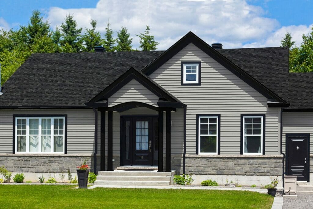 Should Gutters Match Your Roof or Trim? A Style Guide & Image Gallery 5 Black Gutters on a Gray House