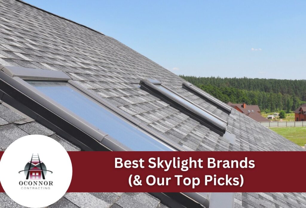 Modern roof skylights on gray shingle roof with forested landscape background